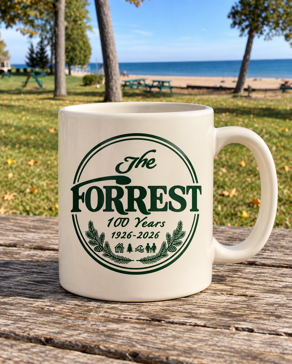 Cream coffee mug with The Forrest 100 Years centennial emblem printed in forest green.