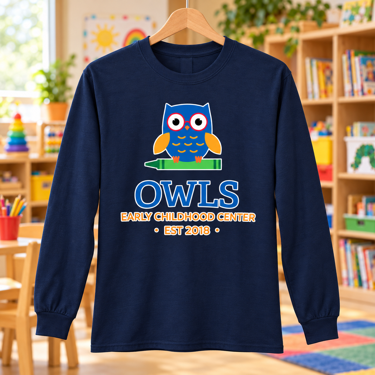 Early Childhood Center owls logo navy PC55LS long sleeve shirt in a classroom