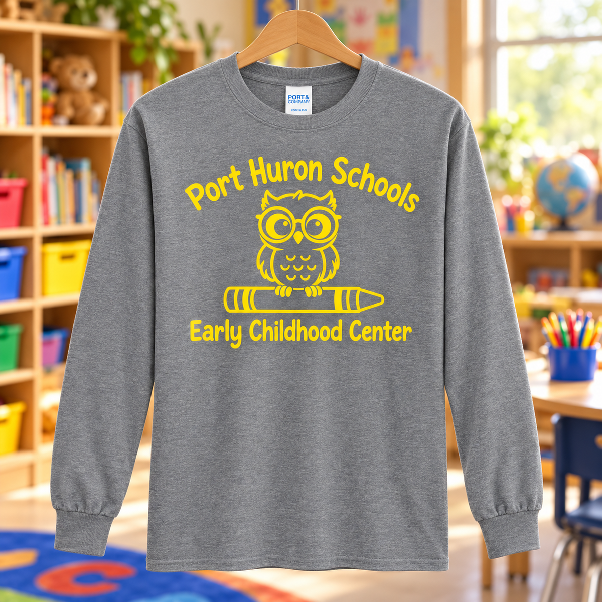 Early Childhood Center yellow logo heather PC55LS long sleeve shirt in a classroom