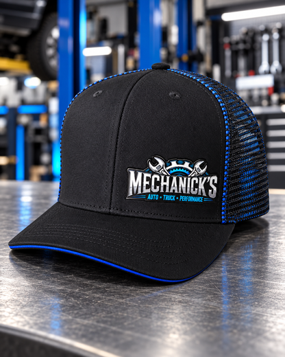 MechaNick’s cap shop blue front with Ace Signature UV patch in automotive workshop