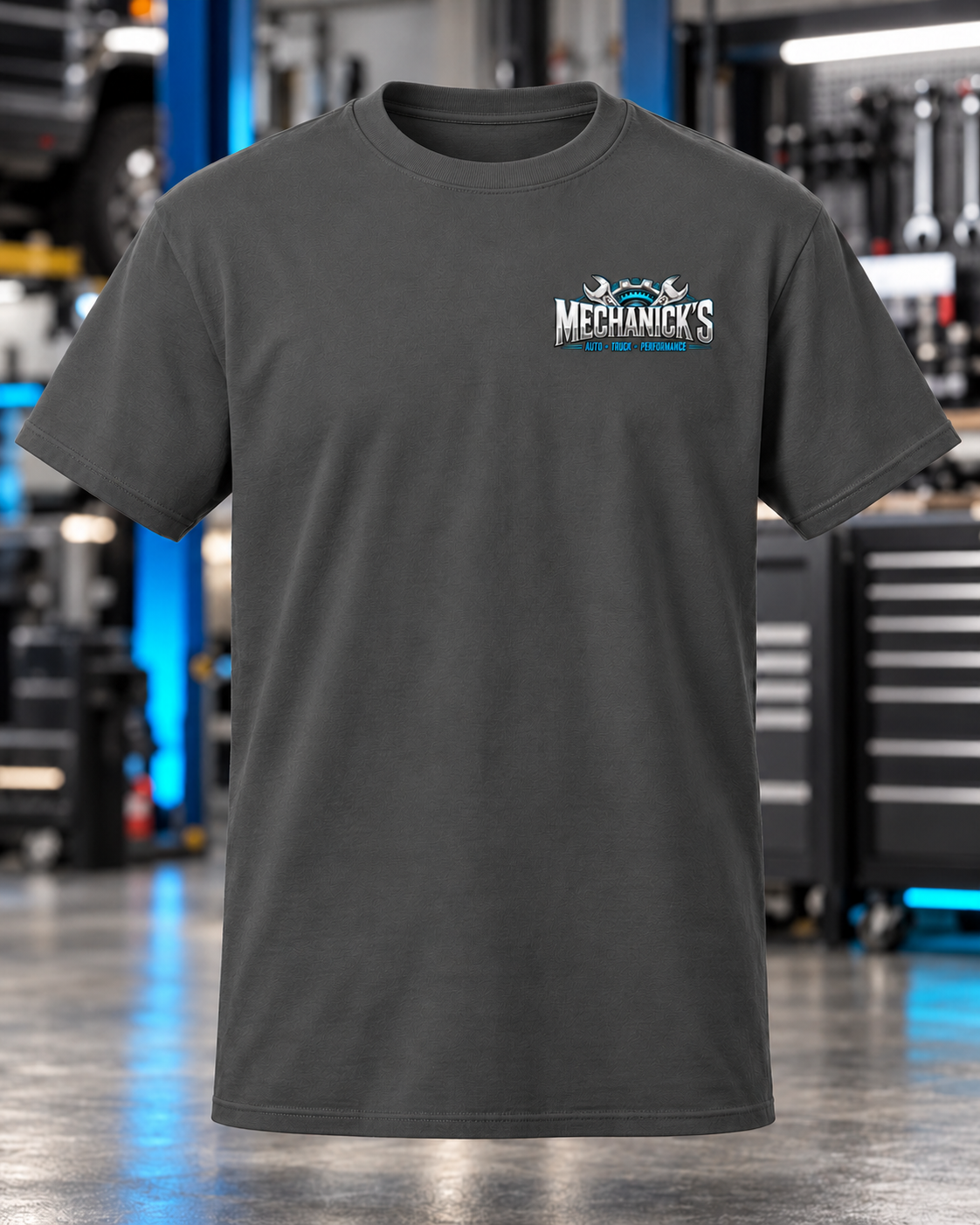 MechaNick’s tee charcoal front with updated artwork in automotive workshop