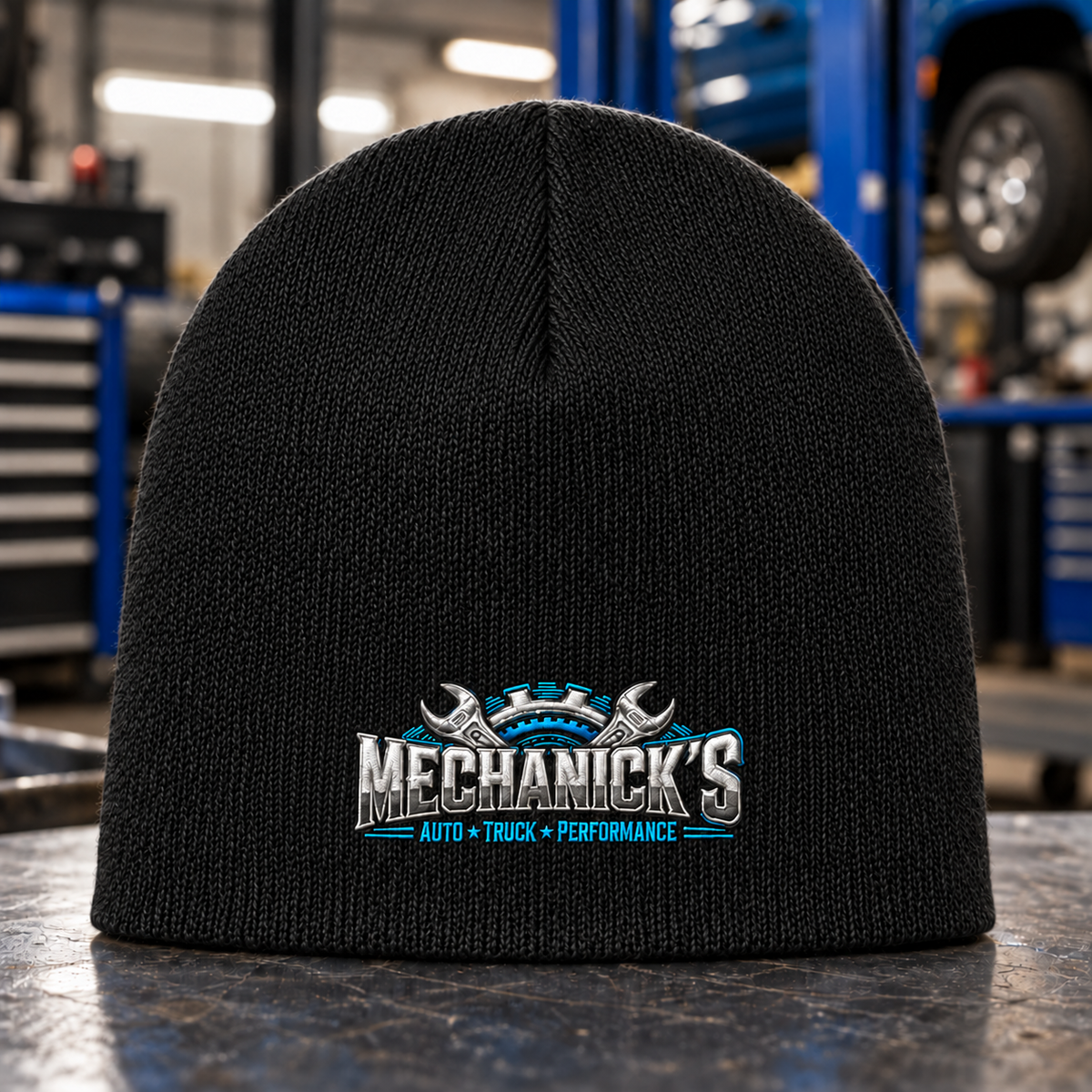 MechaNick’s black knit beanie with smaller centered embroidered crest