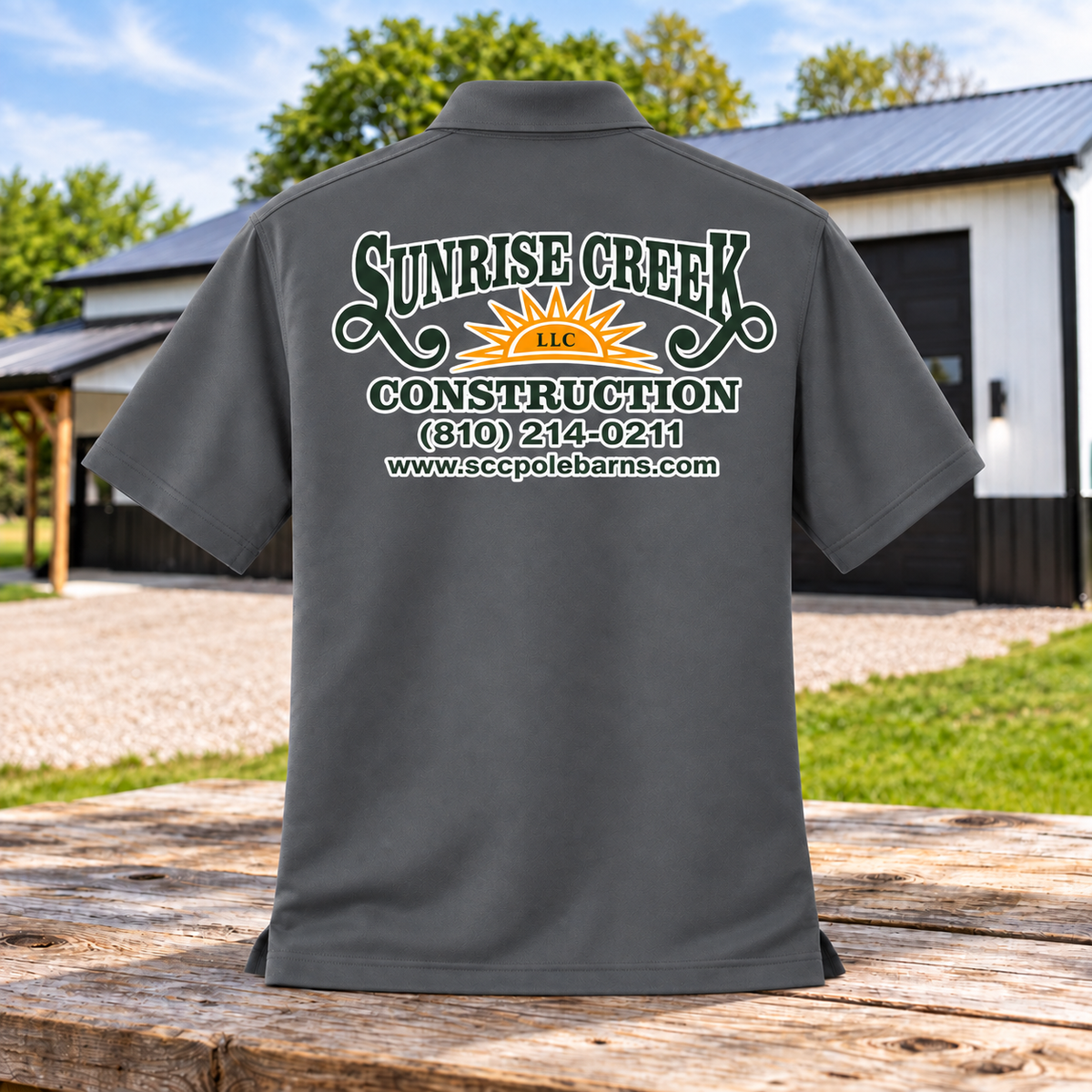 Sunrise Creek K110 in Graphite — back view against a pole barn and weathered timber